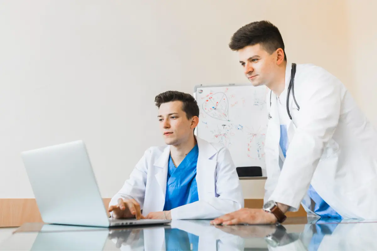 Two doctors discussing patient billing data, representing support for small medical practices